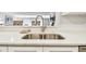 Modern kitchen sink and countertops with a view into the dining area at 36750 Us Highway 19 N # 13301, Palm Harbor, FL 34684