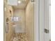 Large walk-in shower with glass enclosure and hexagon tile floor at 36750 Us Highway 19 N # 13301, Palm Harbor, FL 34684