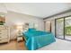 Bright bedroom with a queen bed and access to a private patio at 36750 Us Highway 19 N # 15118, Palm Harbor, FL 34684