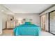Main bedroom with teal bedding and patio access at 36750 Us Highway 19 N # 15118, Palm Harbor, FL 34684