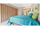 Main bedroom with teal bedding and patio access at 36750 Us Highway 19 N # 15118, Palm Harbor, FL 34684
