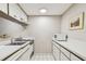 Small kitchen with white cabinets, microwave, and stovetop at 36750 Us Highway 19 N # 15118, Palm Harbor, FL 34684