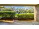 Private patio with view of landscaped grounds and parking at 36750 Us Highway 19 N # 15118, Palm Harbor, FL 34684