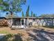 Backyard view of the house, showcasing a screened porch at 4666 86Th N Ave, Pinellas Park, FL 33782