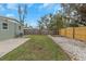 Backyard with grass, concrete patio, and wooden fence at 5144 13Th S Ave, Gulfport, FL 33707