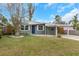 Charming green house with a well-manicured lawn and a modern facade at 5144 13Th S Ave, Gulfport, FL 33707