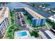Aerial view showcasing building, parking, and waterfront location at 5555 Gulf Blvd # 209, St Pete Beach, FL 33706