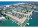 Aerial view of waterfront condo building with parking and water access at 5555 Gulf Blvd # 209, St Pete Beach, FL 33706