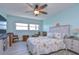 Bright bedroom with ceiling fan, wood-look floors, and coastal decor at 5555 Gulf Blvd # 209, St Pete Beach, FL 33706