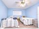 Bedroom with two twin beds and light blue walls at 5555 Gulf Blvd # 209, St Pete Beach, FL 33706