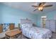 Coastal-themed bedroom with a queen-size bed, ceiling fan, and sitting area at 5555 Gulf Blvd # 209, St Pete Beach, FL 33706