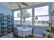 Bright dining area with water views, a round table and a cat tree at 5555 Gulf Blvd # 209, St Pete Beach, FL 33706