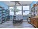 Charming dining area with a round table, water views, and built-in shelving at 5555 Gulf Blvd # 209, St Pete Beach, FL 33706