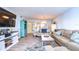 Spacious living area with comfortable seating, a large TV, and views into the kitchen and dining areas at 5555 Gulf Blvd # 209, St Pete Beach, FL 33706