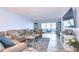 Living room with light walls, hardwood floors, and patio access at 5555 Gulf Blvd # 209, St Pete Beach, FL 33706