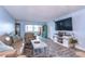 Spacious living room with hardwood floors, and access to a balcony at 5555 Gulf Blvd # 209, St Pete Beach, FL 33706