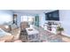 Living room boasts hardwood floors, comfy seating, and large TV at 5555 Gulf Blvd # 209, St Pete Beach, FL 33706