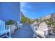 White patio furniture and vibrant flowers at 5555 Gulf Blvd # 209, St Pete Beach, FL 33706