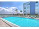 Refreshing community pool with lounge chairs at 5555 Gulf Blvd # 209, St Pete Beach, FL 33706