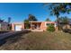 Front view of a single-story house with a garage and lawn at 5611 8Th N Ave, St Petersburg, FL 33710