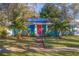 Quaint bungalow with bright blue exterior, solar panels, and lush landscaping at 5719 23Rd S Ave, Gulfport, FL 33707