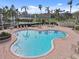 Community pool with plenty of lounge chairs and a hot tub at 6181 Bahia Del Mar Blvd # 209, St Petersburg, FL 33715