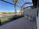 Relaxing screened patio overlooking a pond and houses at 6353 Plateau Ct, Bradenton, FL 34203