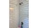 Modern shower with white subway tile and updated fixtures at 6666 Pinellas Point S Dr, St Petersburg, FL 33712