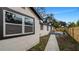 Backyard with gray deck, walkway, and wooden fence at 7209 N Highland Ave, Tampa, FL 33604