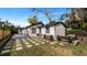 Spacious backyard with deck, patio, and grassy area at 7209 N Highland Ave, Tampa, FL 33604