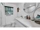 Modern bathroom with white cabinets, marble tile, and a walk-in shower at 7209 N Highland Ave, Tampa, FL 33604