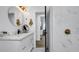 Bright bathroom with white vanity, marble shower, and open to bedroom at 7209 N Highland Ave, Tampa, FL 33604