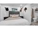 Guest bedroom with gray upholstered bed and hardwood floors at 7209 N Highland Ave, Tampa, FL 33604