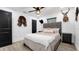 Guest bedroom with gray upholstered bed and hardwood floors at 7209 N Highland Ave, Tampa, FL 33604