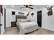 Guest bedroom with a gray upholstered headboard and hardwood floors at 7209 N Highland Ave, Tampa, FL 33604