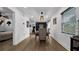 Dining room with hardwood floors and view into the bedroom at 7209 N Highland Ave, Tampa, FL 33604