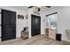 Inviting entryway with dark door, wood-look floors, and storage at 7209 N Highland Ave, Tampa, FL 33604