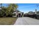 Updated bungalow with a charming front porch and walkway at 7209 N Highland Ave, Tampa, FL 33604