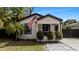 Charming bungalow with a white exterior, black accents, and landscaped front yard at 7209 N Highland Ave, Tampa, FL 33604
