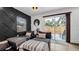 Living area features a black accent wall and sliding glass doors to patio at 7209 N Highland Ave, Tampa, FL 33604