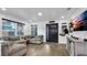Open concept living room with hardwood floors, sectional sofa, and views into kitchen at 7209 N Highland Ave, Tampa, FL 33604