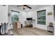 Home office with wood-look floors, neutral walls, and built-in shelving at 7209 N Highland Ave, Tampa, FL 33604