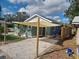 House front view with shade sail and gravel driveway at 825 46Th N St, St Petersburg, FL 33713