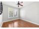 Bedroom with hardwood floors, plantation shutters and mirror at 9546 Cavendish Dr, Tampa, FL 33626