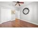 Well-lit bedroom with hardwood floors and ceiling fan at 9546 Cavendish Dr, Tampa, FL 33626