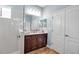 Clean bathroom with white tiles, double vanity, and wooden cabinets at 10527 Falling Leaf Ct, Parrish, FL 34219