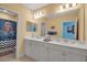 Double vanity bathroom with a shower and decorative accents at 10527 Falling Leaf Ct, Parrish, FL 34219