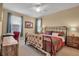 Large bedroom with a king-size bed, wooden nightstands, and teal curtains at 10527 Falling Leaf Ct, Parrish, FL 34219