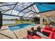 Enclosed pool area with patio furniture and lake view at 10527 Falling Leaf Ct, Parrish, FL 34219