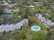 Aerial view of community with pool, tennis court and condos at 1111 N Bayshore Blvd # F6, Clearwater, FL 33759